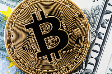 Fototapeta na wymiar Bitcoin on the background of the American dollar close-up, top view