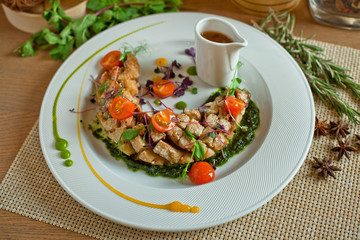 meat ragout with tomatoes in a white dish on a wooden table