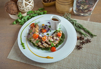 meat ragout with tomatoes in a white dish on a wooden table