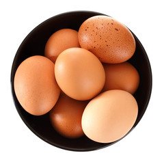 Eggs in a clay bowl. Isolated on white background. View from above