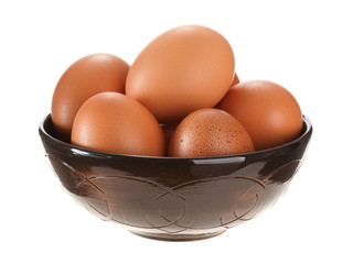 Eggs in a clay bowl. Isolated on white background.