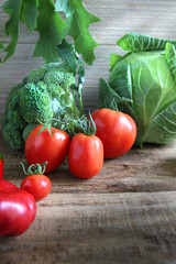 Tomatoes and cabbige on the wooden background