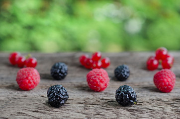 Various fresh berries on wooden background. Copy space