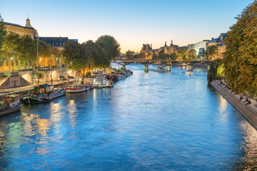 Paris at night - sunset over Seine river and street with lights