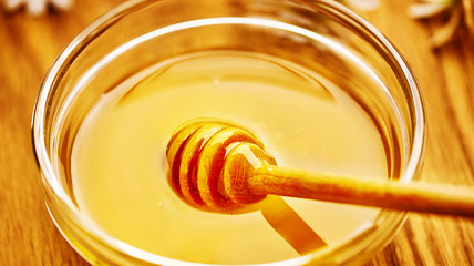 Honey in glass bowl. Healthy organic. Sweet dessert background