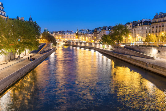 Fototapeta Paris at night - sunset over Seine river and street with lights