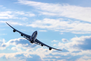 Airplane flying over cloudy sky. Commercial travel airline concept. Turn right.