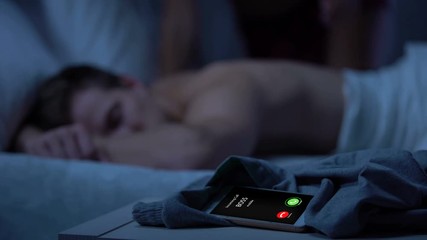 Boss calling while lady coming and kissing sleepy male on background, business