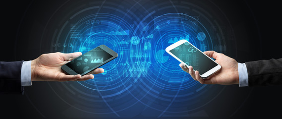 Close up of two smartphones syncing business data
