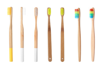 Set with bamboo toothbrushes on white background