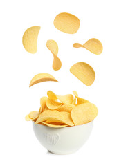 Bowl of tasty crispy potato chips on white background