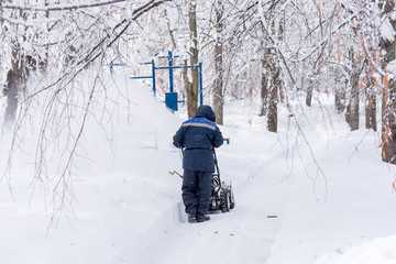 Clearing paths in the Park after the snow. Russia. Moscow.