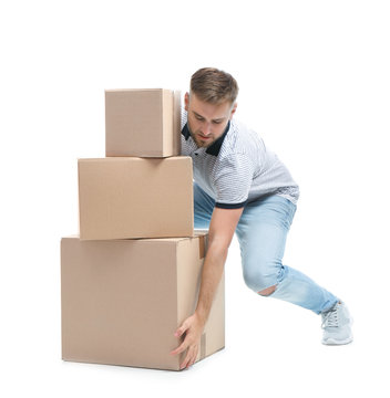 Full length portrait of young man lifting carton boxes on white background. Posture concept