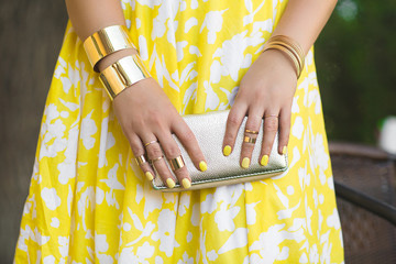 Unrecognizable woman holding wallet in her hands. Lady`s hands wearing rings and accessiories. Girl...