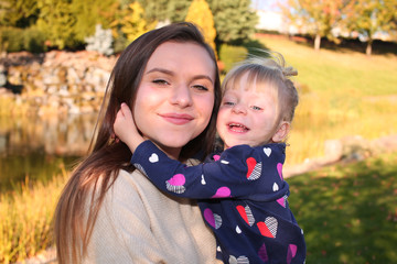 Close up, Portrait, Two Beautiful  Happy Sisters, in the park in the open air, Golden Autumn Background