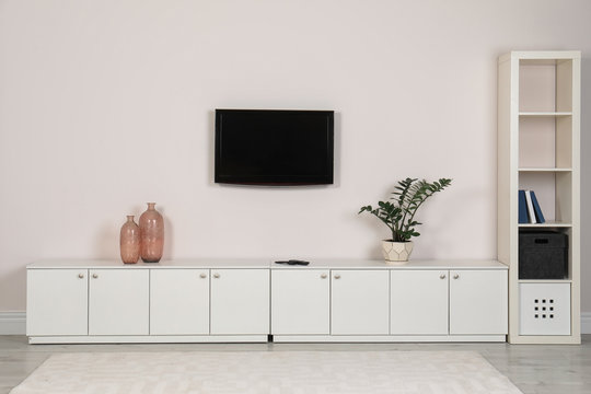 Modern TV set mounted on wall in living room