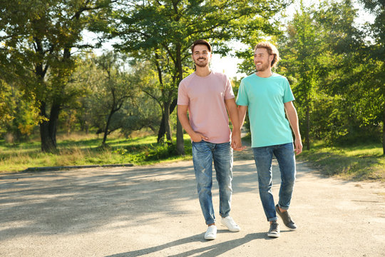 Happy Gay Couple Walking In Green Park