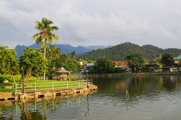 Fototapeta na wymiar View over Mae Hong Son Pond showing mountainous terrain of Northern Thailand