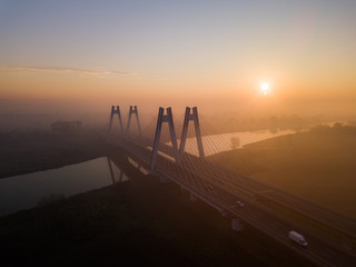 Obraz premium foggy bridge on the Vistula at sunset, Krakow, Poland