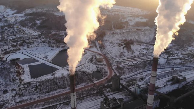 Aerial view of smoke rising from the chimney of a coal boiler. Top view, rotate the camera.