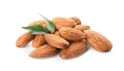 Organic almond nuts and leaves on white background. Healthy snack