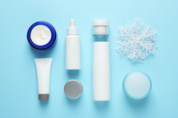 Set of cosmetic products on blue background, flat lay. Winter care