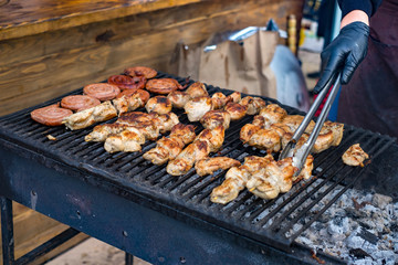 Marinated shashlik preparing on a barbecue grill over charcoal (skewered meat).
