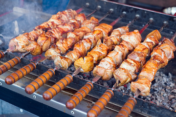 Marinated shashlik preparing on a barbecue grill over charcoal (skewered meat).