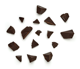 Broken, cracked or crushed dark chocolate parts from top view isolated on white background