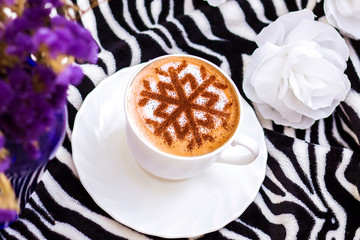 Cappuccino with a pattern of snowflakes