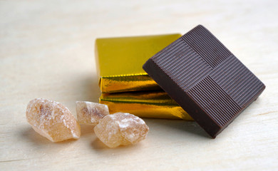 Chocolate in gold cover and lumps of brown sugar.