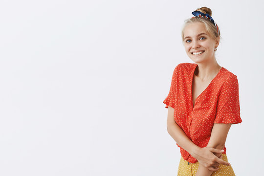 Woman Asking Boyfriend For White Dance. Studio Shot Of Charming Emotive And Cute Timid And Shy Girl With Blond Hair Combed With Headband Wearing Trendy Polka-dot Blouse, Smiling And Touching Arm