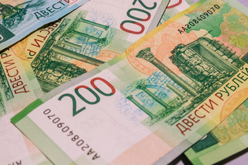 background of new banknotes worth 200 rubles. Russian currency
