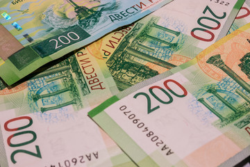 background of new banknotes worth 200 rubles. Russian currency