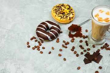 Latte coffee arabica espresso beans donuts dark chocolate background.