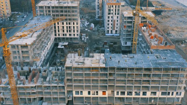 Aerial view of a group of houses in a course of building on a big construction site
