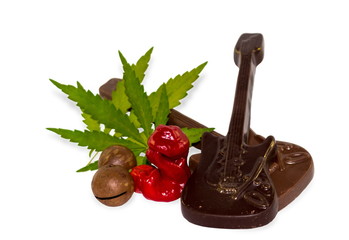 Sex, drugs, rock-n-roll. Chilly Willy pepper as sex, chocolate as rock music, cannabis leaf as drug on white background. Conceptual background about social problems and prohibitions in modern society