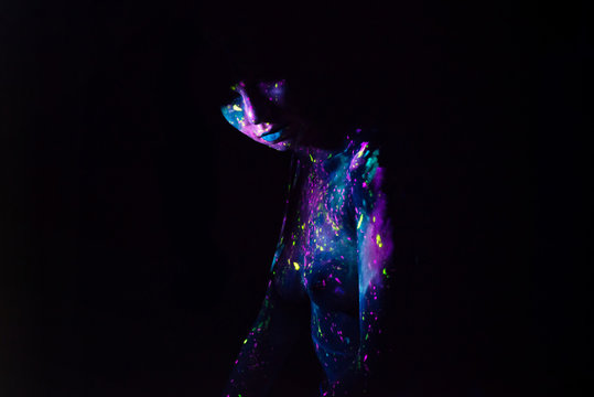 Bodypainting on nude girl painted with UV colors