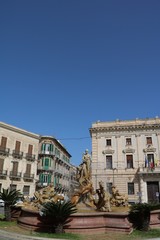 Fototapeta na wymiar The Fontana di Artemide at Piazza Archimedes in Syracuse, Sicily Italy