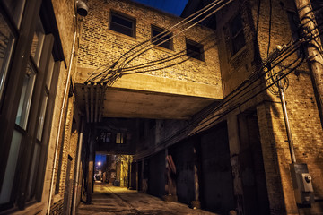 Dark and scary downtown urban city street alley scene with an ee