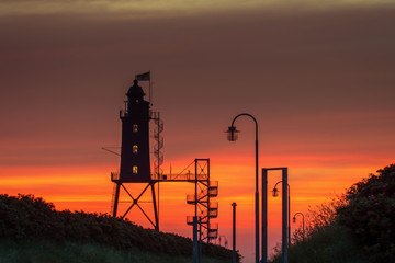 The former lighthouse Eversand-Oberfeuer built in 1886/87 is now a museum and a tourist attraction. Here during the sunset. Concept: travel and vacation