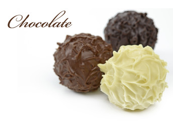 Chocolate balls or White, milky and dark chocolate truffles isolated on white background