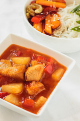 Flat lay noodles with vegetables and chiken with sweet and sour sauce