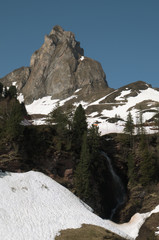 Local peak and waterfall descending to the Seebenalpsee in Spring, Swiss Alps