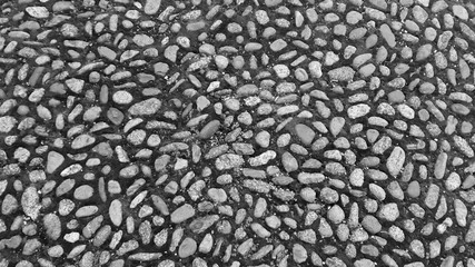Stone pavement texture black and white. cobblestone background