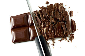 Chopped Chocolate with knife isolated on white background