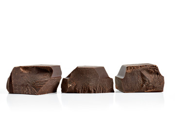Broken or cracked dark chocolate bars or pieces isolated on white background