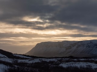 The glow of late afternoon sun through the clouds over central Iceland