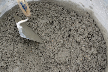 trowel with cement mortar in construction site