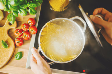 Man cooking pasta in boiling water